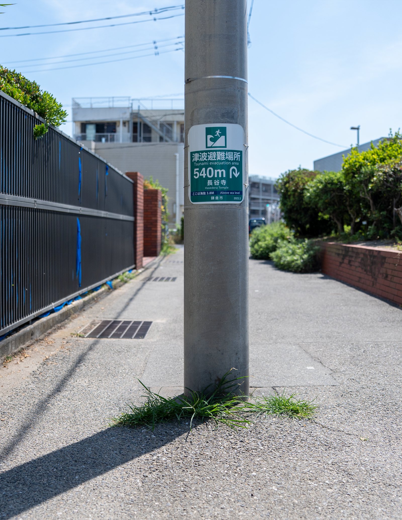 Existing green and white 540m marker on a utility pole